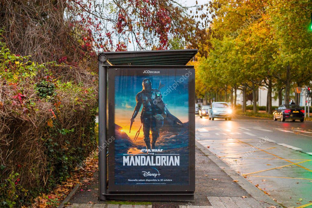 Strasbourg, France - Nov 1, 2020: Street view of public bus station JCDecaux with advertising for the upcoming Star Wars the Mandalorian