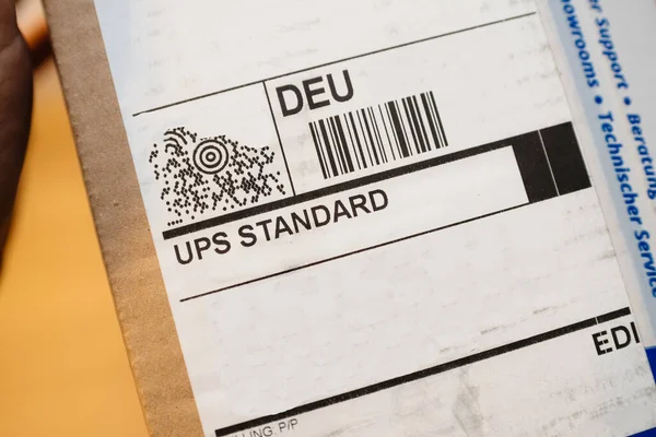 Close-up macro shot of UPS standard inscription on the sticker of a delivered parcel — Stock Photo, Image