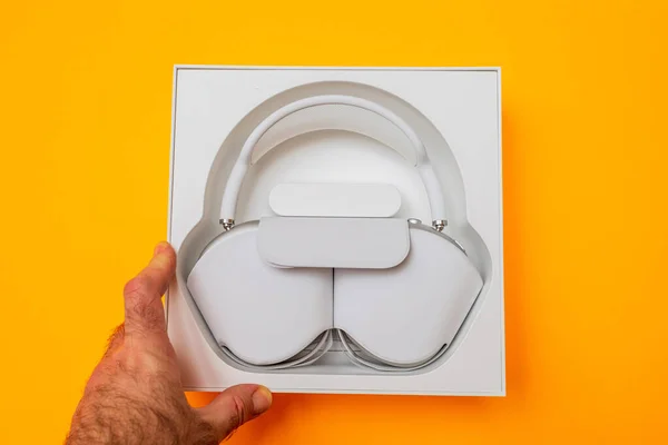 POV male had at view from above of package of the best Apple Computers AirPods Max — Stock Photo, Image