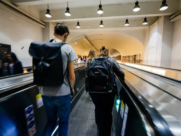 Parisian underground metro scene with few commuters people on the escalator taking the fastest route to interchanges with other lines — Stock Photo, Image