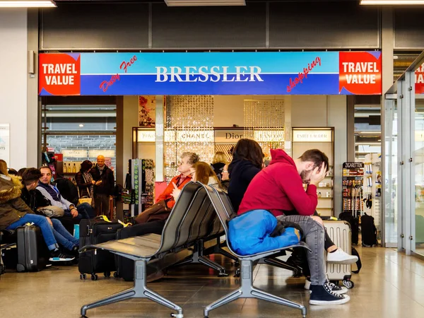 Κουρασμένοι επιβάτες που περιμένουν στον τερματικό σταθμό στο μικρό αεροδρόμιο Baden με Bressler κατάστημα αφορολόγητων ειδών — Φωτογραφία Αρχείου