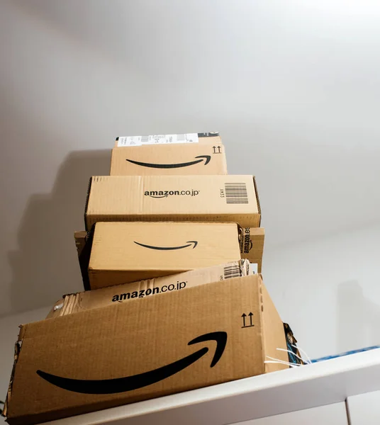 Stack of multiple e-commerce Amazon.com and AMazon.co.jp cardboard parcel box — стокове фото