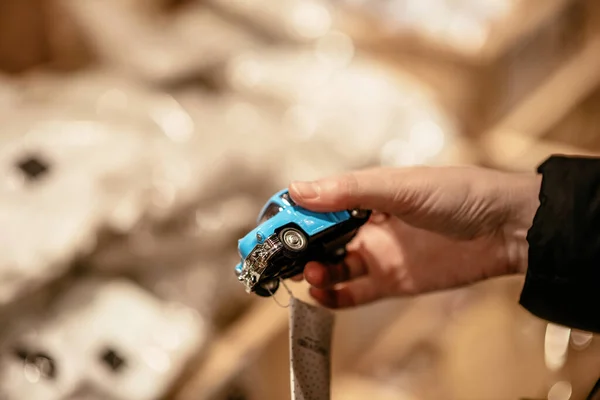 Man holding new small vintage blue toy car in hand — Stock Photo, Image