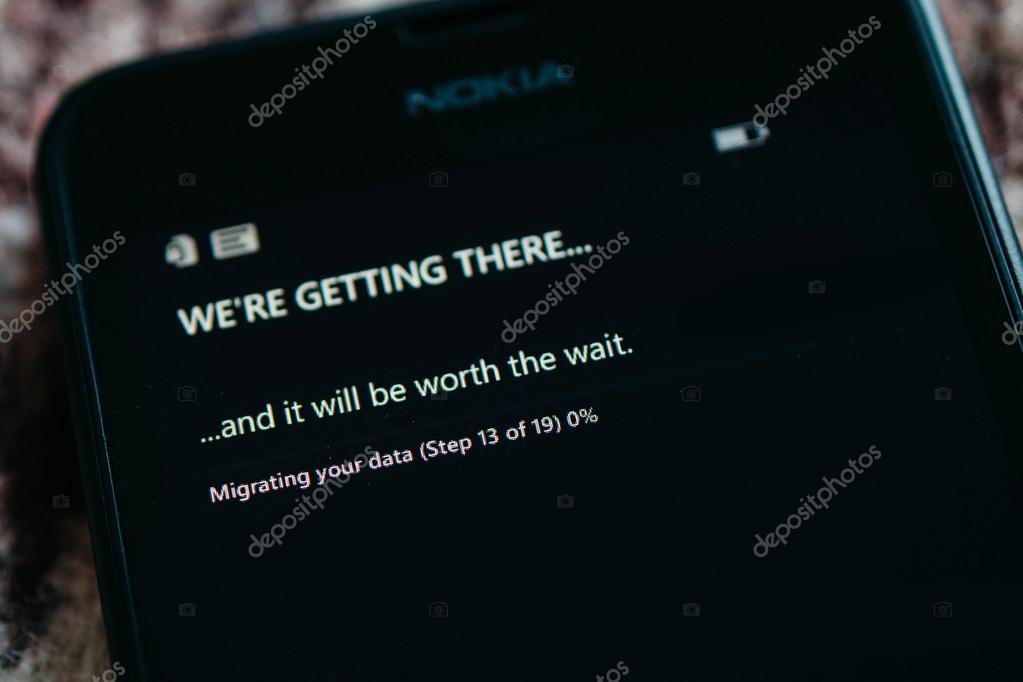 LONDON, UNITED KINGDOM - NOVEMBER 9, 2014: Nokia Lumia smartphone first run with message We're Getting There on the screen. Microsoft has announced that it will stop using Nokia branding on all future mobile phone