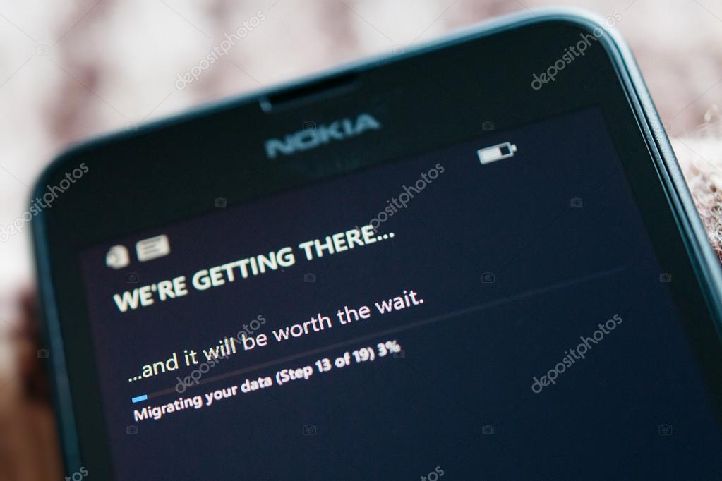LONDON, UNITED KINGDOM - NOVEMBER 9, 2014: Nokia Lumia smartphone first run with message We're Getting There on the screen. Microsoft has announced that it will stop using Nokia branding on all future mobile phone