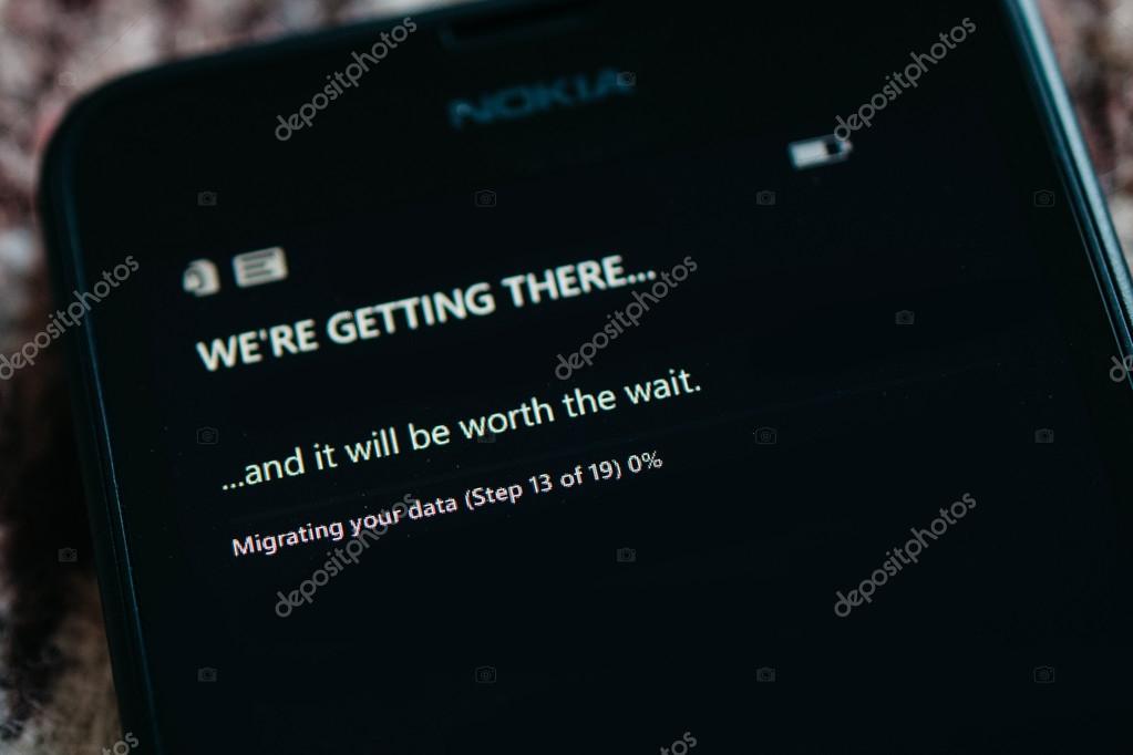 LONDON, UNITED KINGDOM - NOVEMBER 9, 2014: Nokia Lumia smartphone first run with message We're Getting There on the screen. Microsoft has announced that it will stop using Nokia branding on all future mobile phone