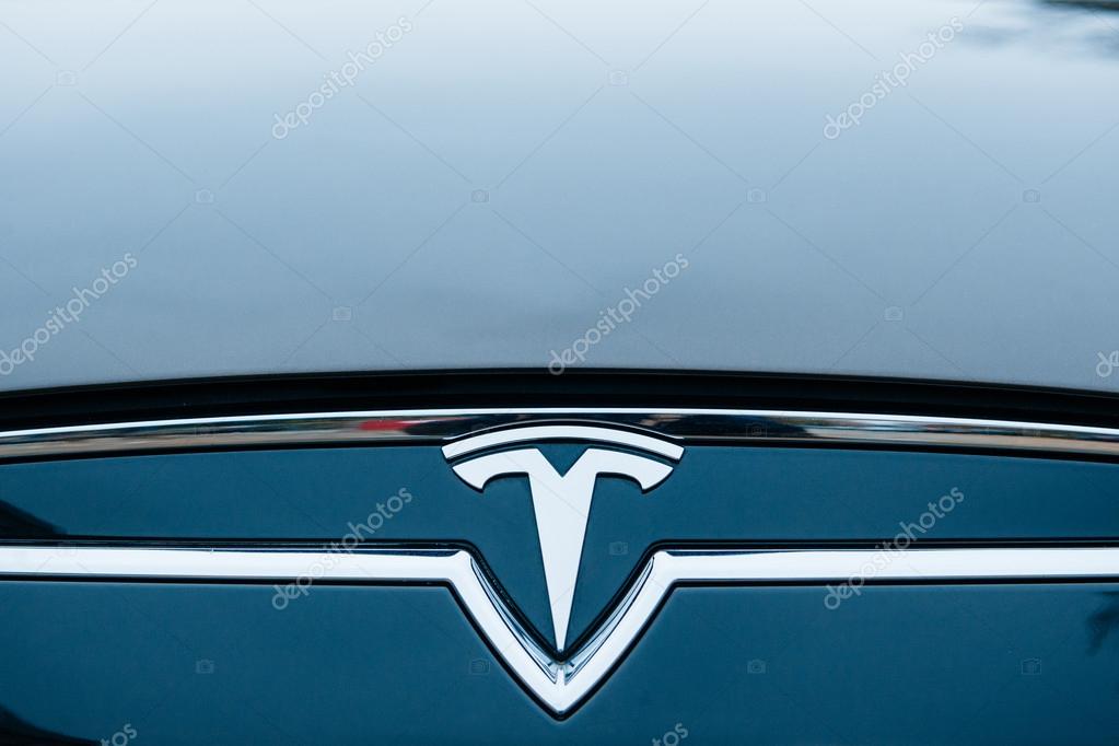 PARIS, FRANCE - NOVEMBER 29:  The Tesla Motors Inc. badge and logo are seen below the hood of the Model S electric vehicle displayed at the company's showroom in Paris, France