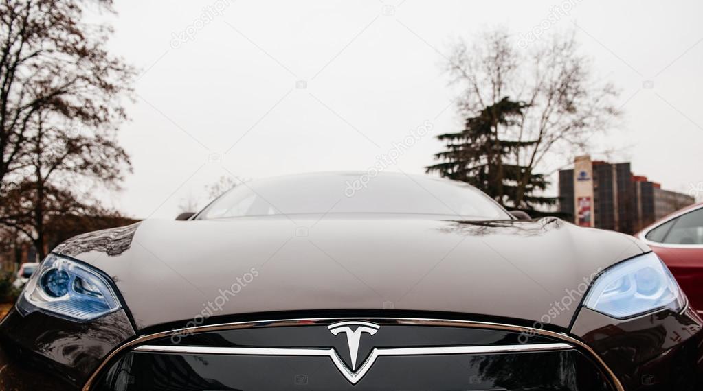 PARIS, FRANCE - NOVEMBER 29:  The Tesla Motors Inc. frontal view of badge head-lights and logo are seen below the hood of the Model S electric vehicle displayed at the company's showroom in Paris, France