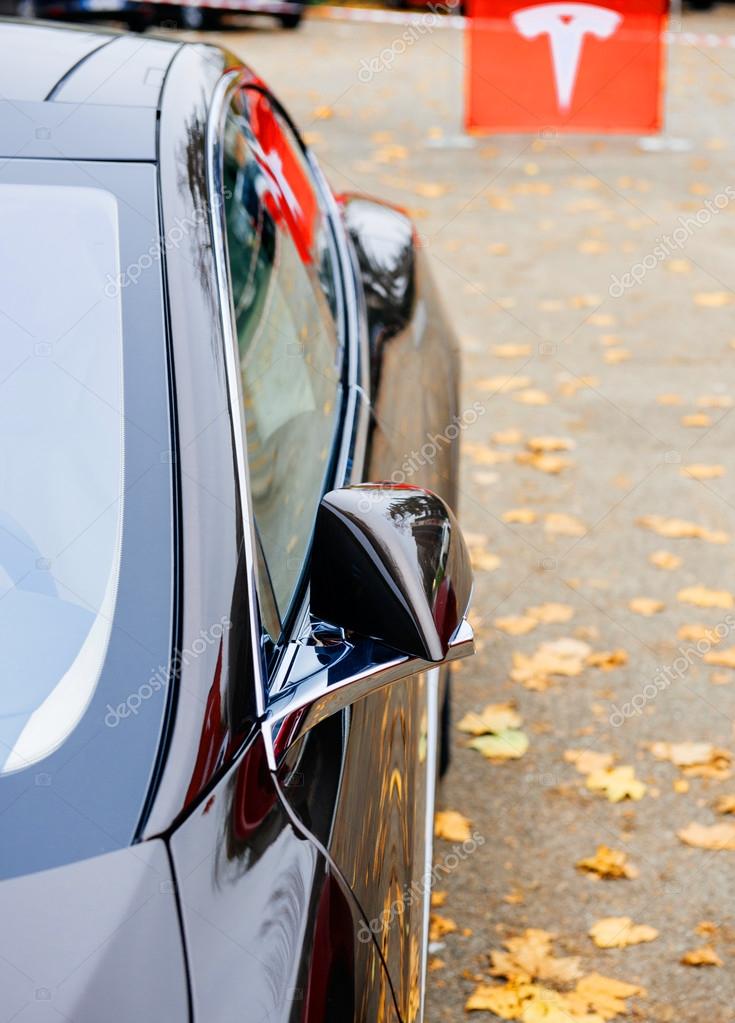 PARIS, FRANCE - NOVEMBER 29: Detail of Tesla Model S Sport Car with tesla sign in the background