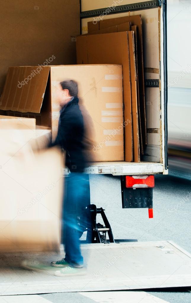 Man unloading boxes from a truck
