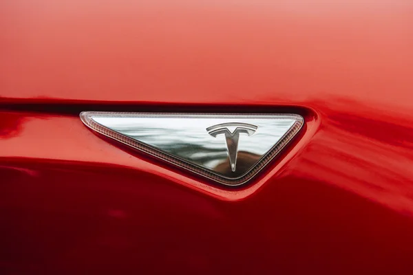 Tesla μάρκα σήμανση σε ένα αυτοκίνητο κόκκινου φορείο — Φωτογραφία Αρχείου