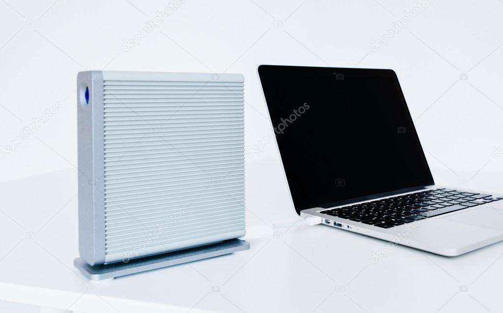Modern laptop computer with external hard disk drive connected t