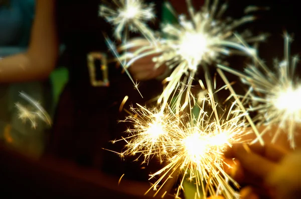 Sparkler in hands on a party
