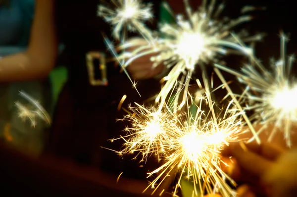 Sparkler in hands on a party — Stock fotografie