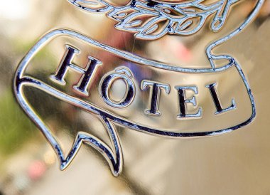 Hotel word engraved on golden plate