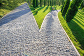 Perspective view of two cobblestone roads decision