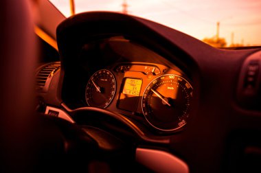 Red tone car dashboard with regular odometer speed