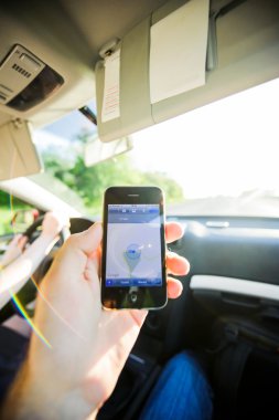 Man navigation inside car GPS iPhone direction