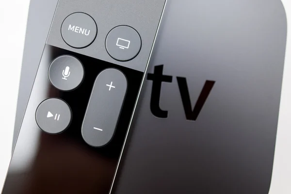 Siri remote over New Apple TV console — Zdjęcie stockowe