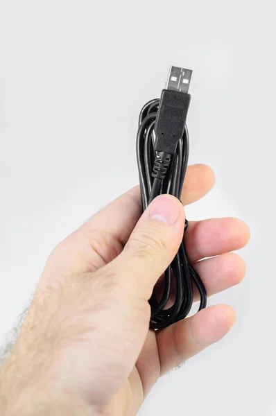 Man holding USB cable — ストック写真