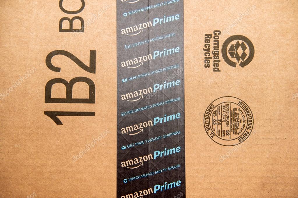 PARIS, FRANCE - JAN 28, 2016: Amazon Prime logotype printed on cardboard box security scotch tape. Amazon Prime is a service from Amazon which delivers parcels in 1 day, streams unlimited music and video gives access to unlimited Books on Kindle stor