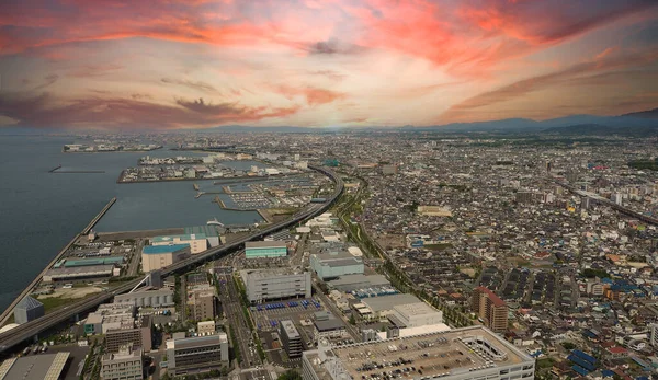 Aerial view or bird eyes view images of Kansai bay area Osaka Japan include big premium outlets located across from Kansai International Airport and it's largest airport in western Osaka bay Kansai Japan.