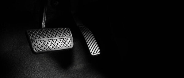 Close up the foot pressing foot pedal of a car to drive. Accelerator and brake pedal in a car. Driver driving the car by pushing accelerator and break pedals of the car. inside vehicle. control pedal.