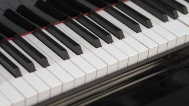 Grand piano. Professional piano keys self playing. close-up seamless loop. for classical musical music education. Black and white piano keys that play on their own. AI Self Playing Without Pianist.