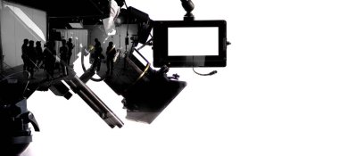 Silhouette images of film production. behind the scenes or b-roll of making video commercial movie. Film crew lightman and cameraman working together with film director in studio. Film industry.
