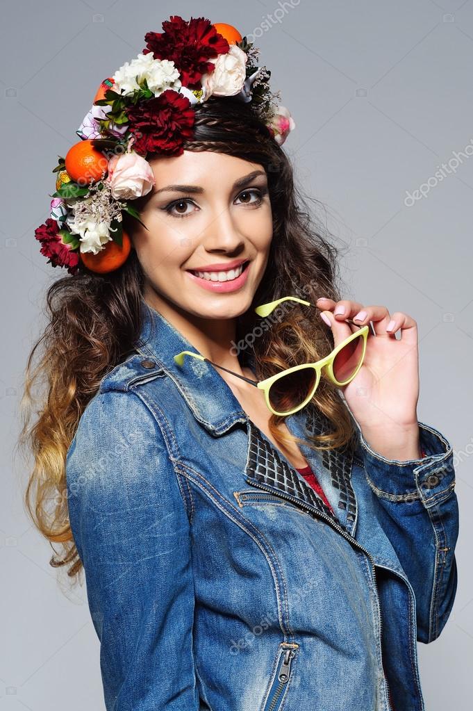 Beautiful woman in flower crown holding sunglasses Stock Photo by  ©zoiakostina 101579392