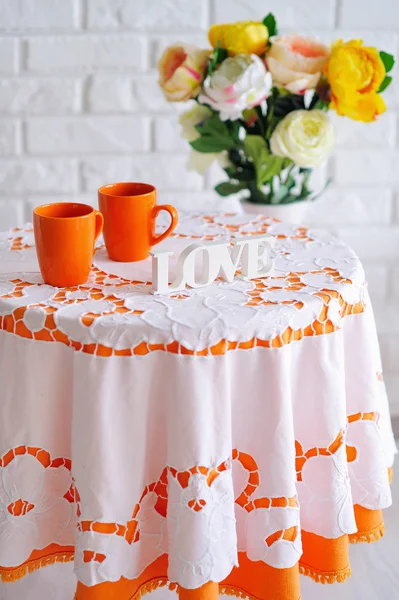 Nature morte de printemps avec des fleurs et des tasses orange — Photo