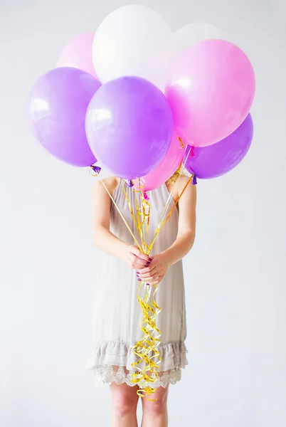 Woman behind bunch of balloons — Stock Photo, Image