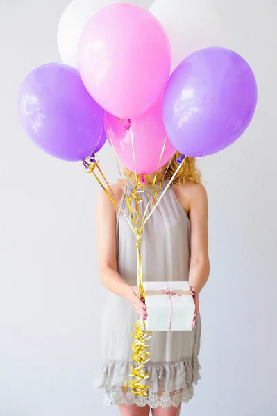 Woman behind bunch of balloons — Stock Photo, Image