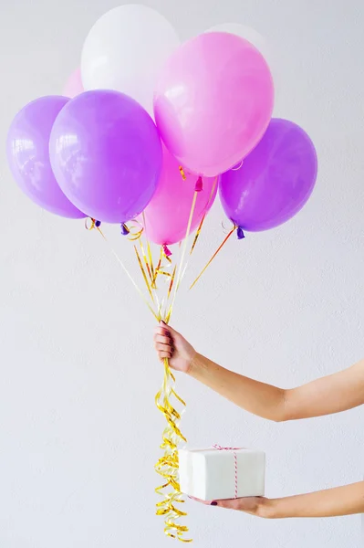 Mulher mãos segurando monte de balões — Fotografia de Stock