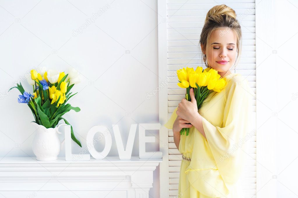 Beautiful woman with yellow tulips