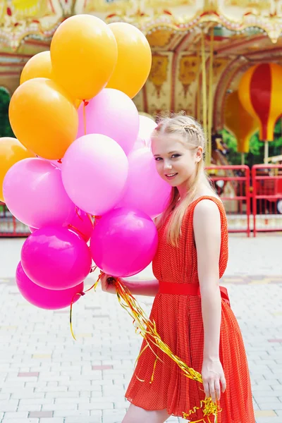 Young model woman smiling with colorful balloons — Stock Photo, Image