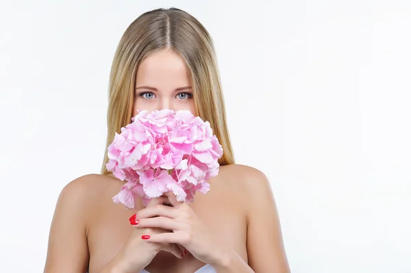 Woman hiding her face behind pink hydrangea — Stock Photo, Image