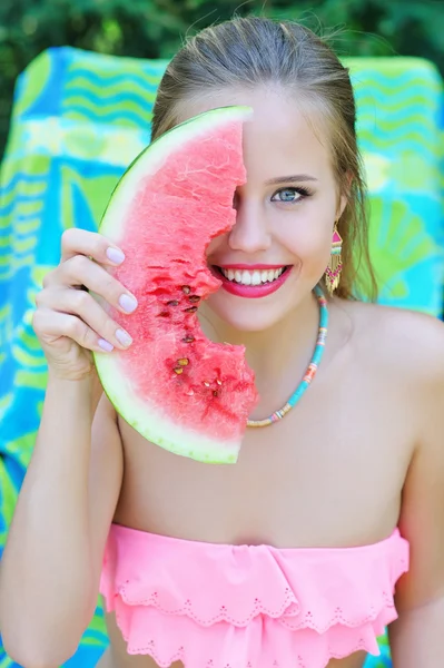 Woman covering her face with watermelon slice — Stock Photo, Image