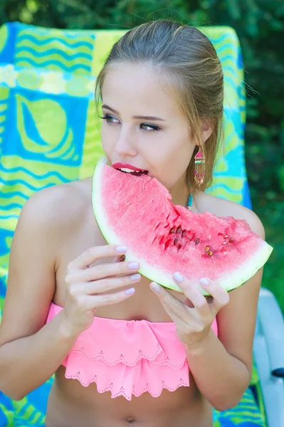 Beautiful trendy woman eating watermelon — Stock Photo, Image