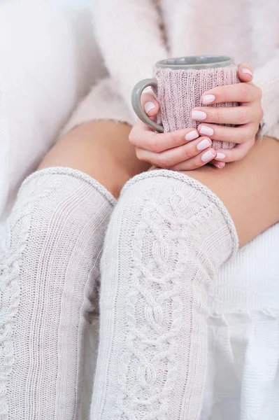 Woman legs and hands and knitted accessories