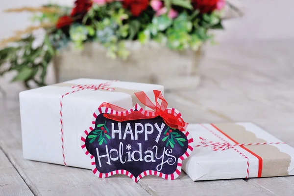 Still life with Happy Holidays sign and boxes — Stock Photo, Image
