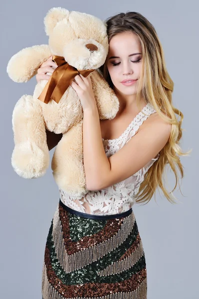 Fancy woman hugs bear toy — Stock Photo, Image