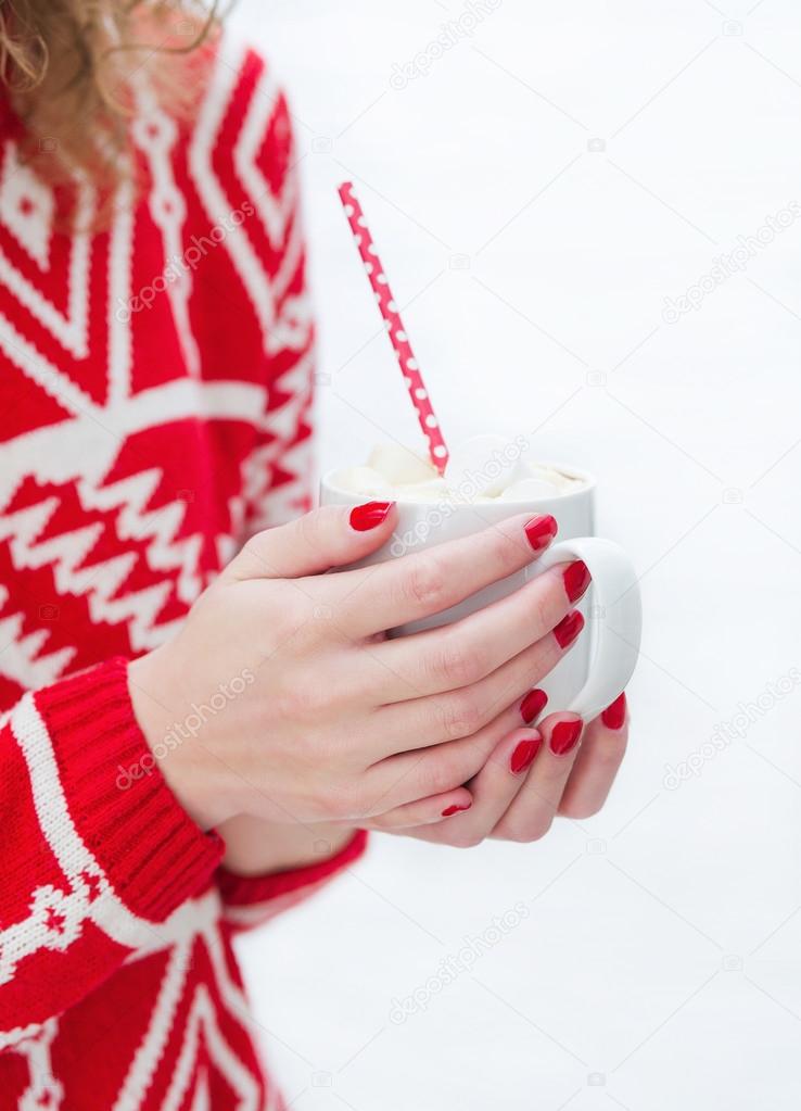 Woman hands holding mug with hot chocolate