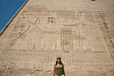 woman in facade of Medinet Habu Temple clipart