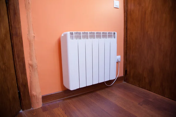 white radiator orange wall