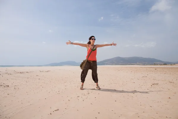 Woman greeting wind in Tarifa beach — ストック写真