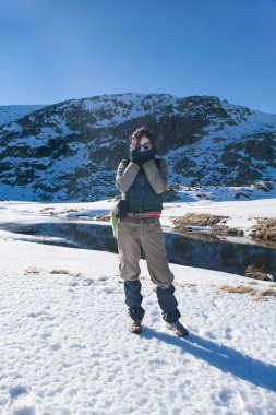 woman in snow looking cold