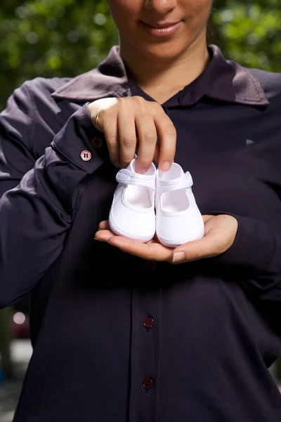 Bootees detail in woman hand — Stock Photo, Image