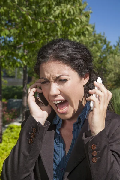 Anger woman shouting two phones — Stock Photo, Image