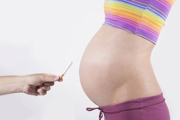 Cigarette for tummy pregnant — Stock Photo, Image